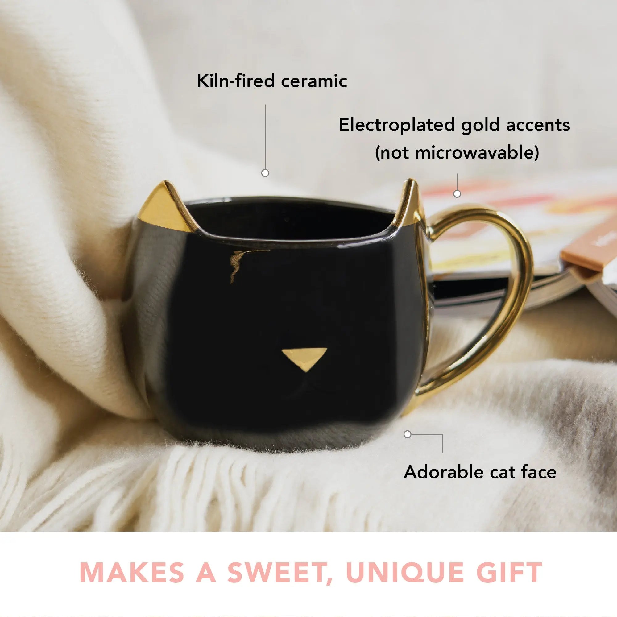 Black cat-shaped mug with gold accents on a soft surface, labeled as kiln-fired ceramic with electroplated gold accents.