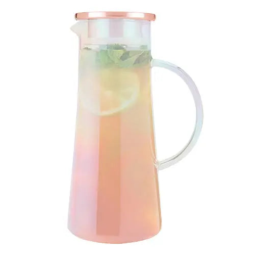 Gradient pink to clear pitcher with lemon slices and mint leaves on a white background