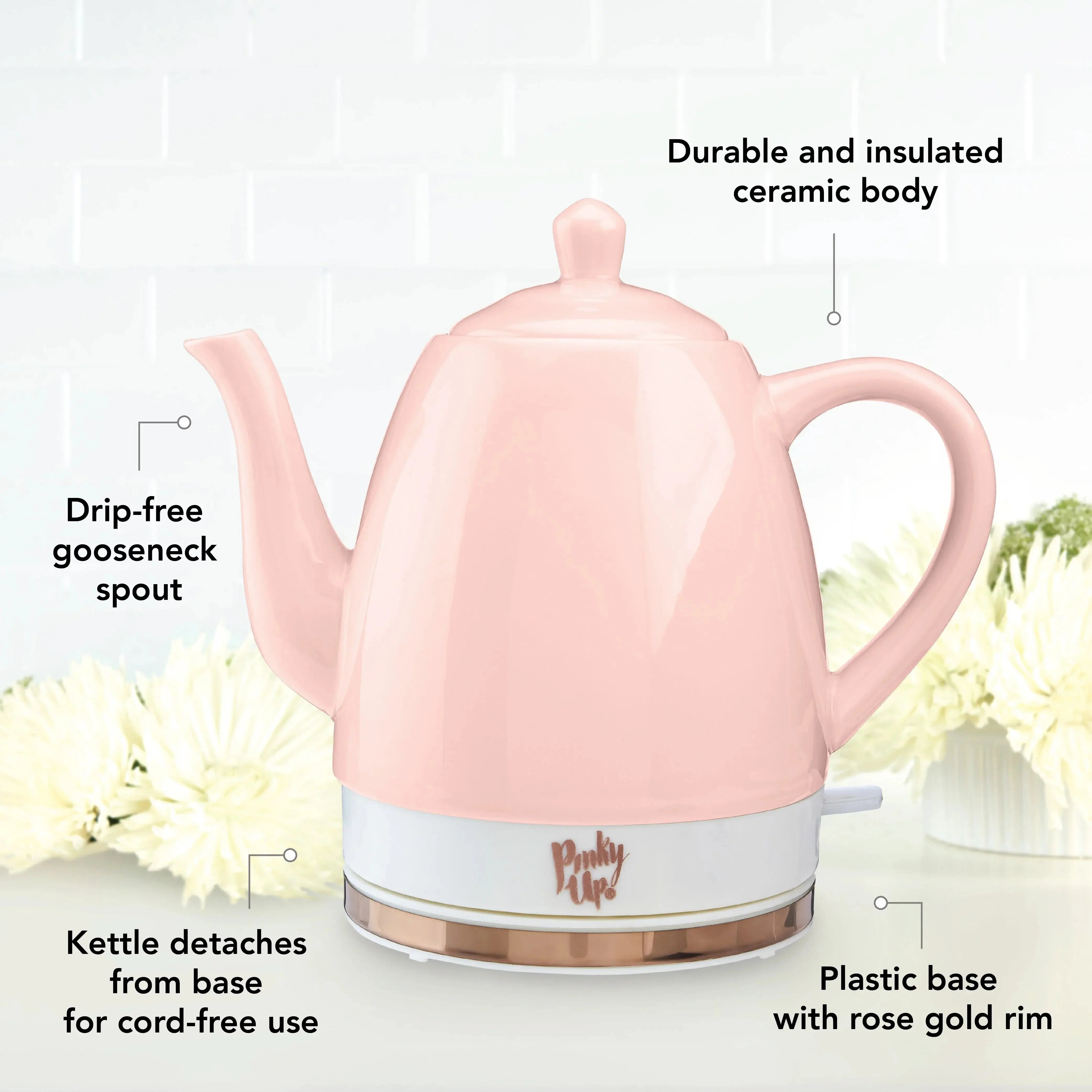 Pinky Up Tea Pot pink with gold trim on a countertop.