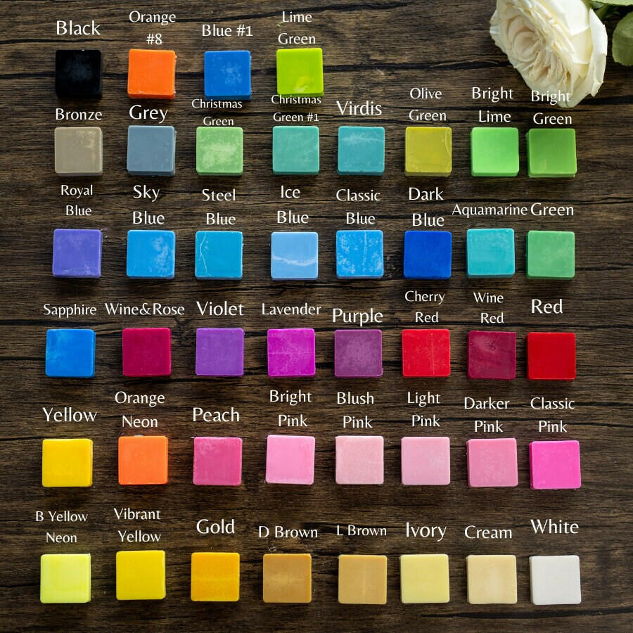 Color swatch chart on a wooden background with a white flower.