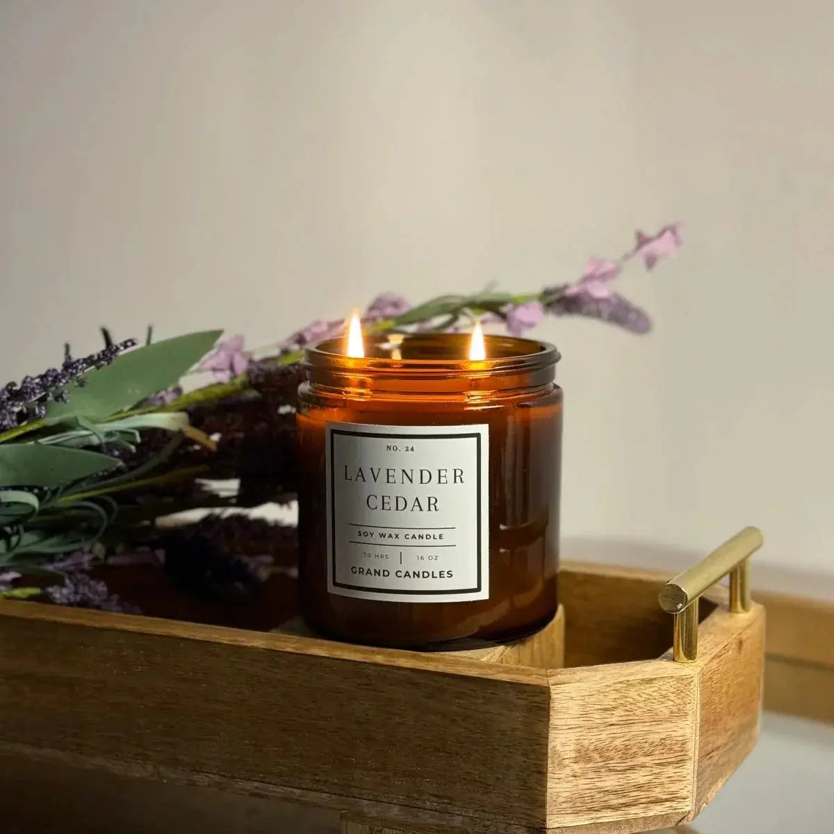 Lavender Cedar soy wax candle in amber jar, lit on wooden tray with dried flowers, farmhouse home decor