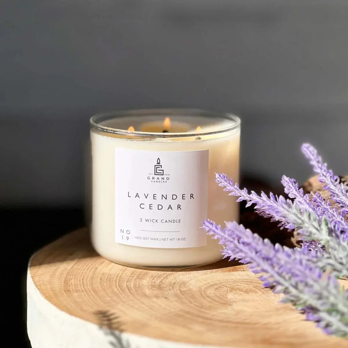 Lavender Cedar 3-wick soy candle on rustic wood with lavender sprigs, cozy farmhouse decor