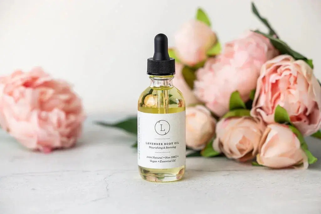 Lavender body oil with dropper, surrounded by pink peonies for cozy home spa vibes