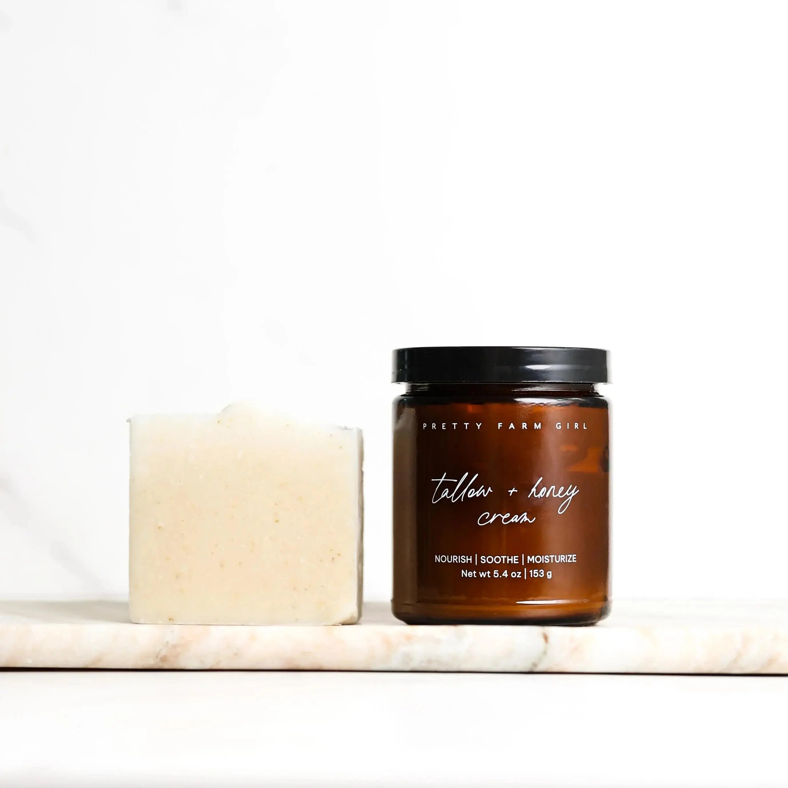 Tallow + honey cream jar and bar soap on marble, farmhouse bath essentials for nourish soothe moisturize