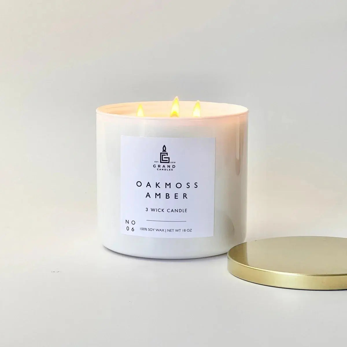 Oakmoss Amber 3-wick soy candle with gold lid, cozy home decor lighting
