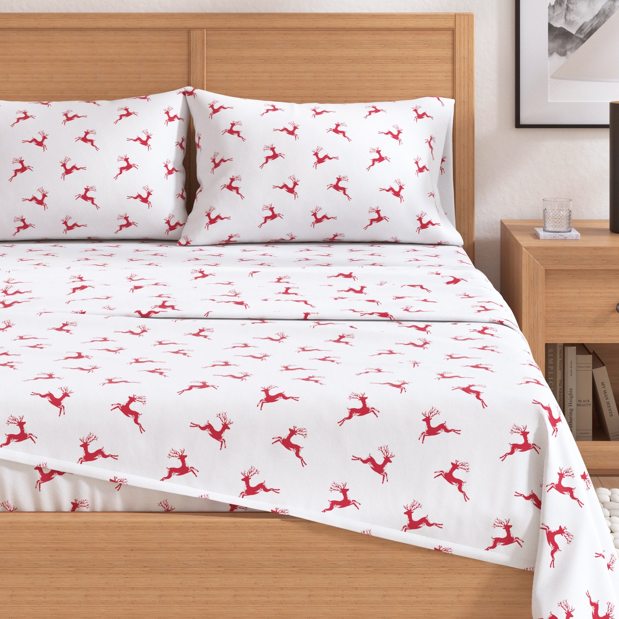White bed sheets with red deer pattern on a wooden bed in a bedroom setting.
