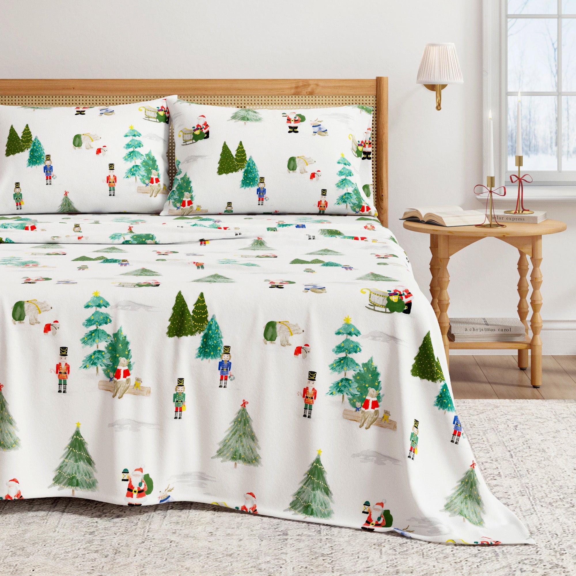 Christmas-themed bedspread with trees and people on a bed in a room with a lamp and table.