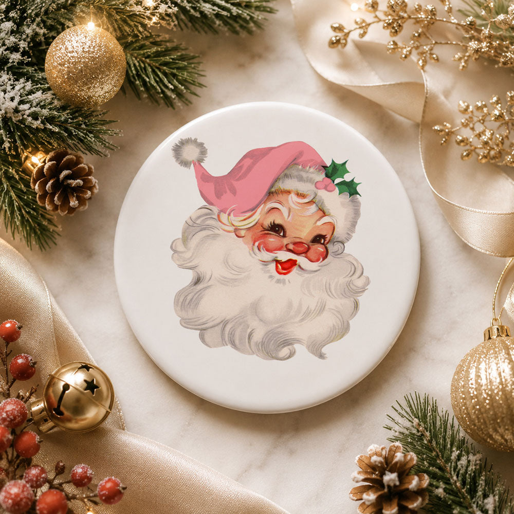 Decorative plate with a cartoon Santa Claus design surrounded by Christmas decorations on a marble surface.