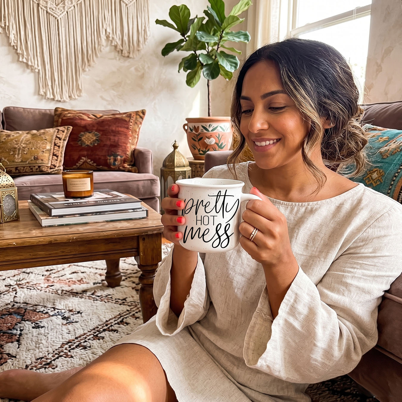 Woman holding a mug with 'bless your heart' text in a cozy living room.