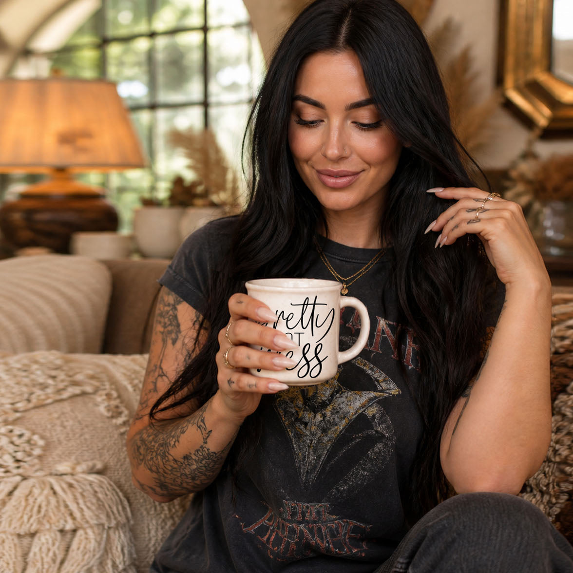 Woman holding a mug with text, sitting on a couch in a cozy living room.