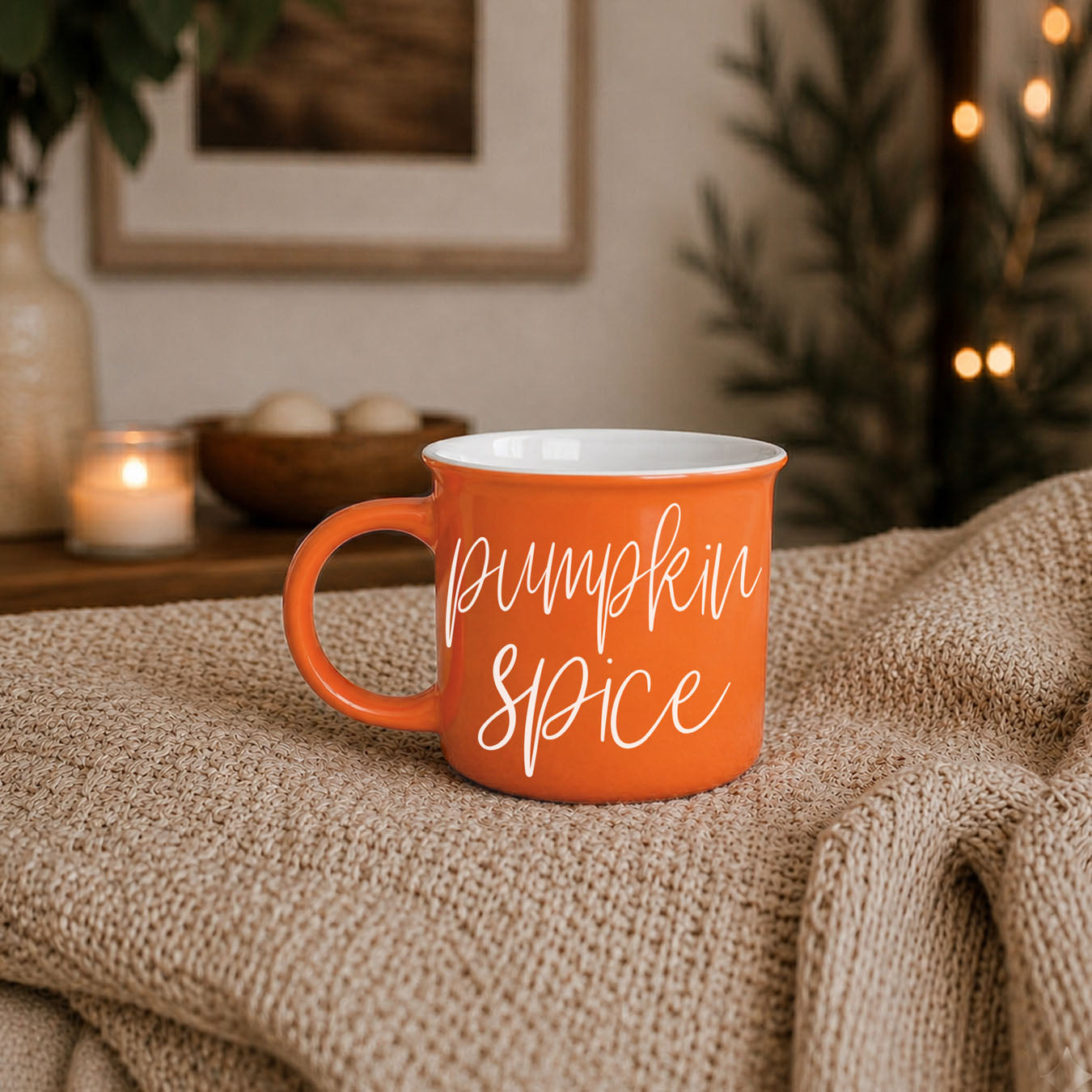Orange 'Pumpkin Spice' mug on a textured surface with a cozy background