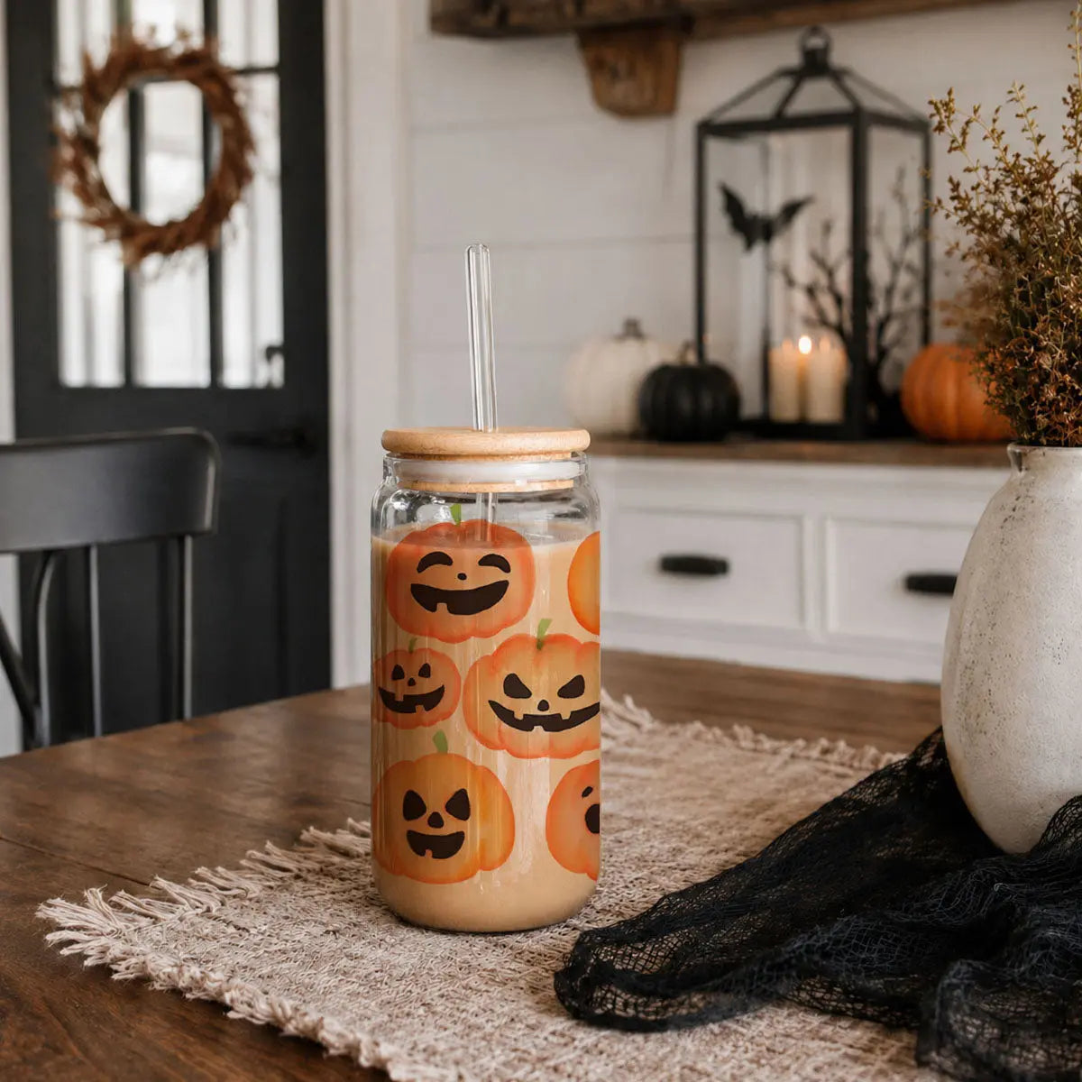 Tumbler with Halloween-themed design on a table with decorative items.