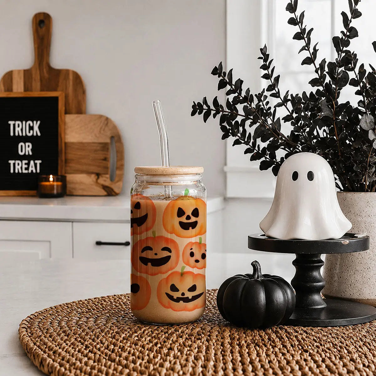 Halloween-themed drink in a jar with pumpkin design, ghost decoration, and 'Trick or Treat' sign.
