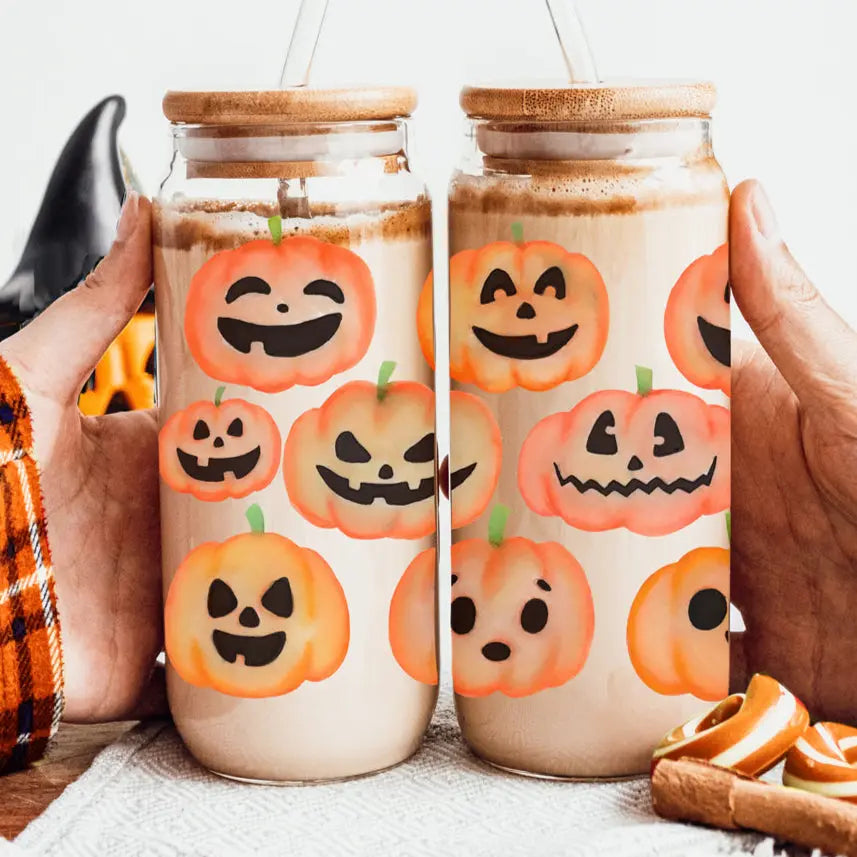 Two jars with pumpkin face designs on a white background