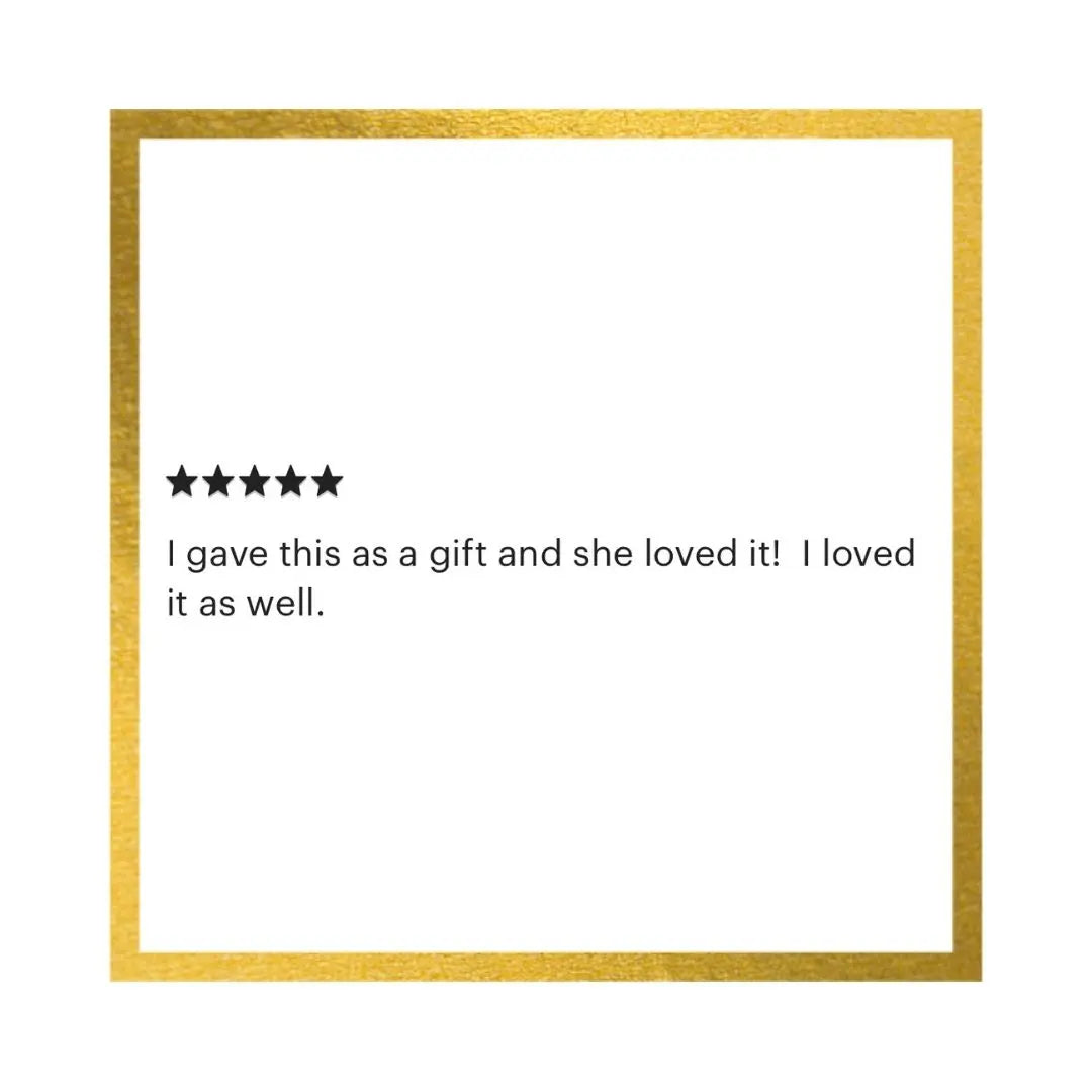 A square white card or print with a textured gold border, featuring a five-star rating graphic and the quote, 'I gave this as a gift and she loved it! I loved it as well.' in black text.