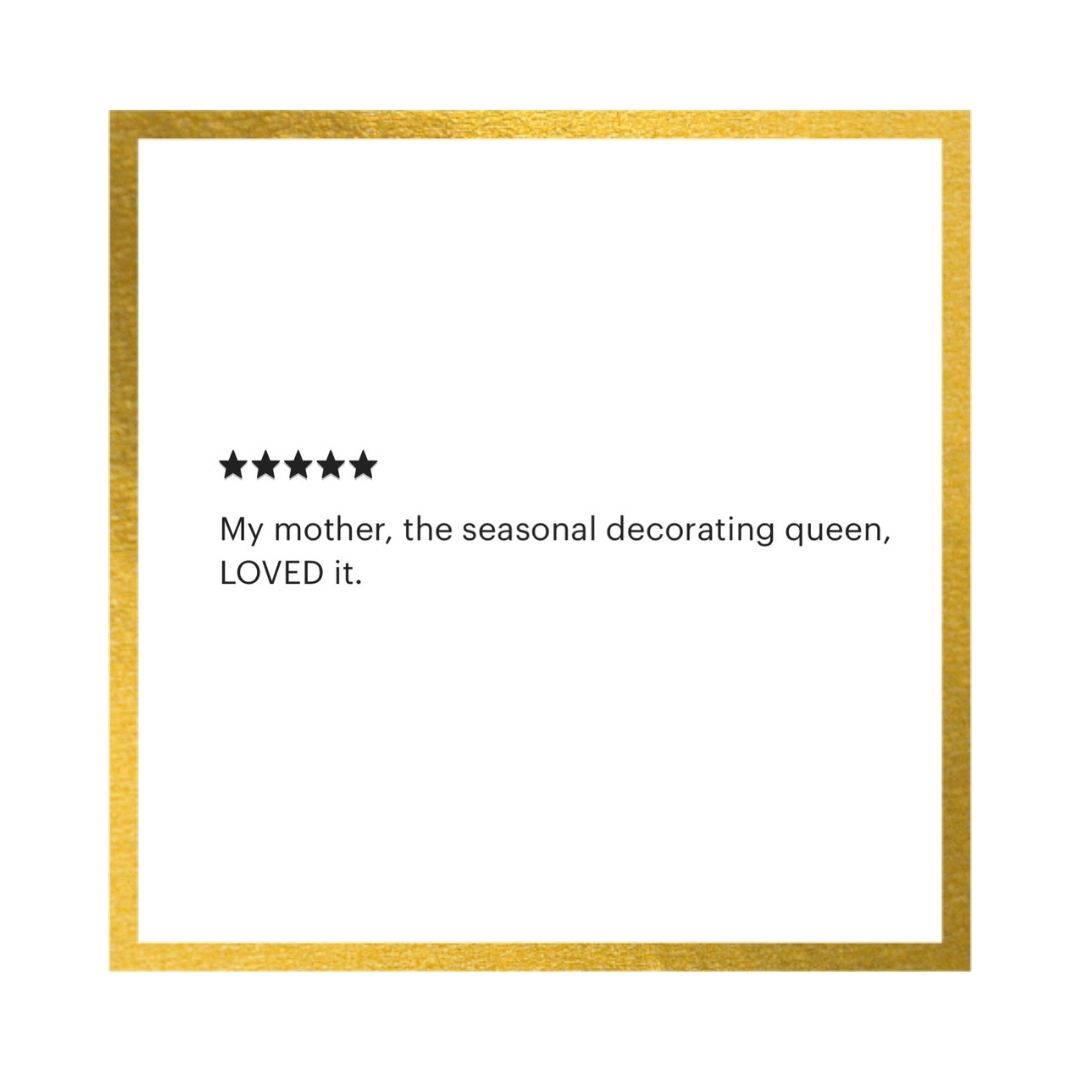 A square white card or print with a metallic gold border, featuring a five-star rating graphic and the text: 'My mother, the seasonal decorating queen, LOVED it.' on a white background.