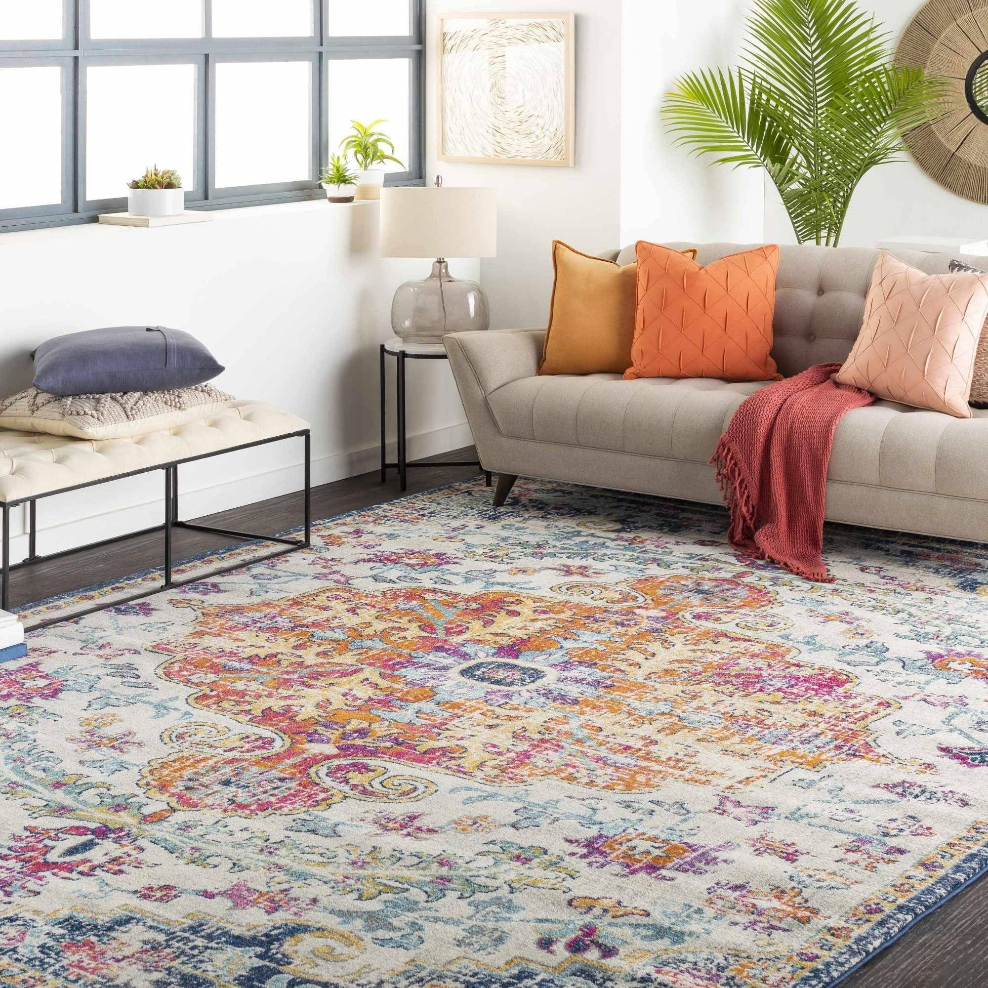 Cozy living room with colorful boho rug, tufted sofa, throw pillows, and farmhouse decor accents
