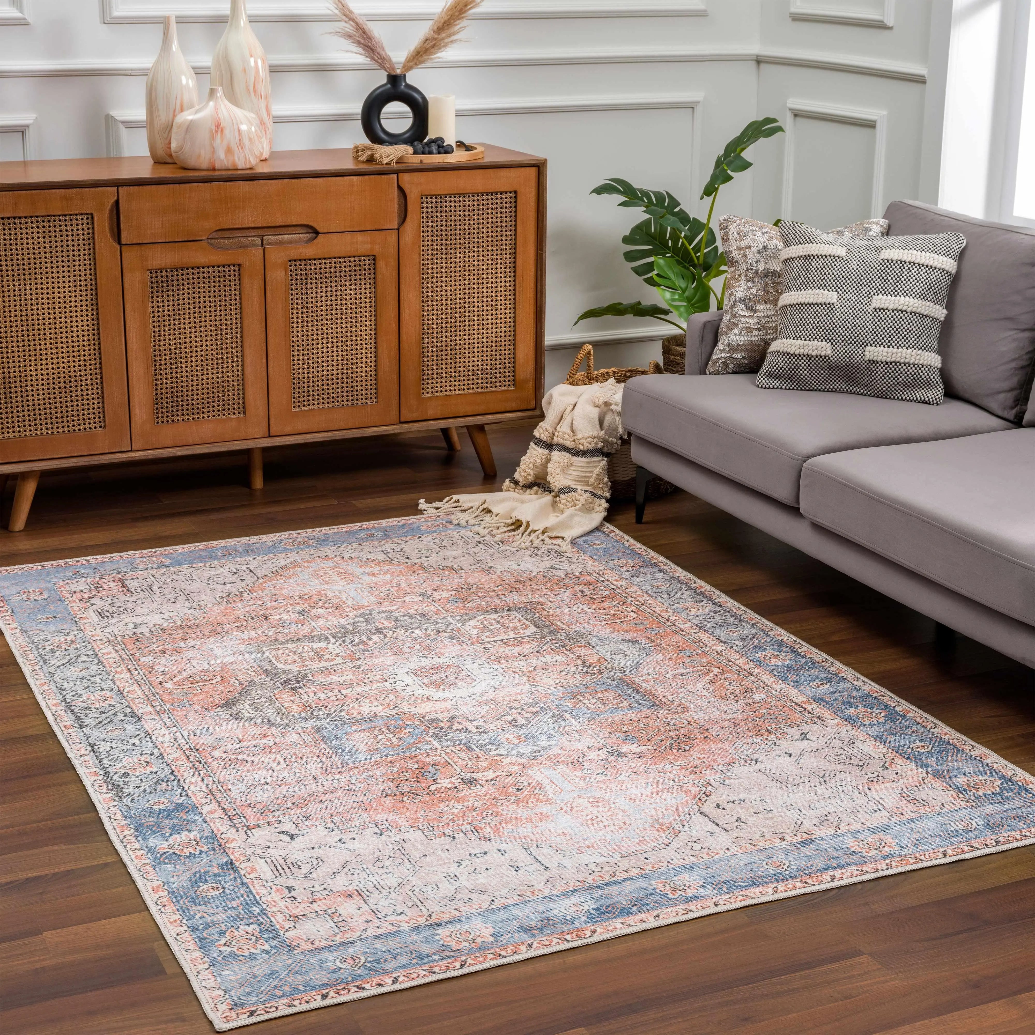 Cozy farmhouse-style area rug with vintage pattern in blue and coral, perfect for living room decor