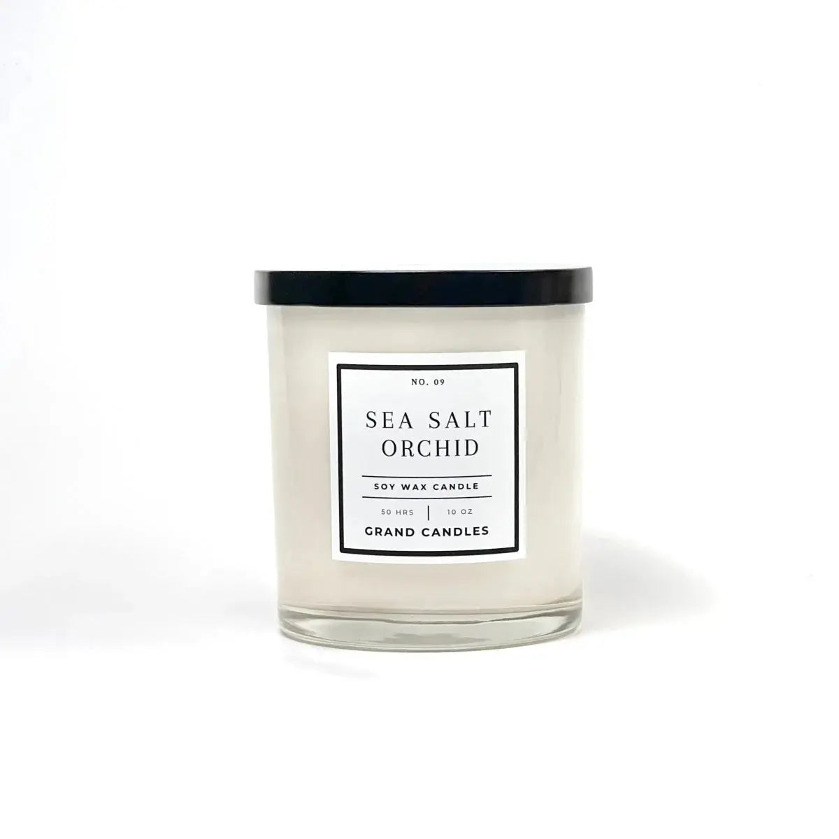 Sea Salt Orchid soy wax candle in clear glass jar with black lid, cozy home decor
