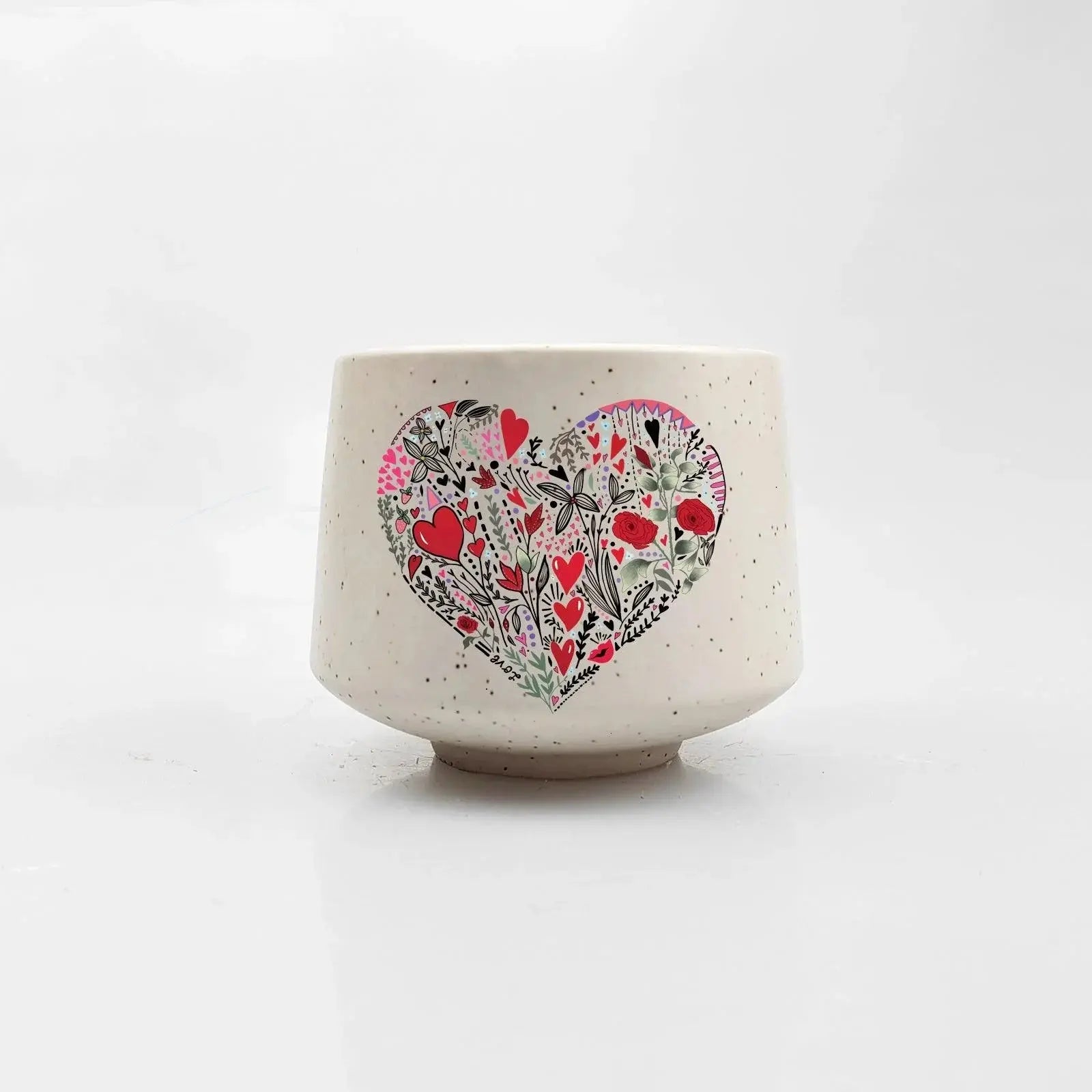 Speckled ceramic mug with floral heart design, cozy farmhouse decor