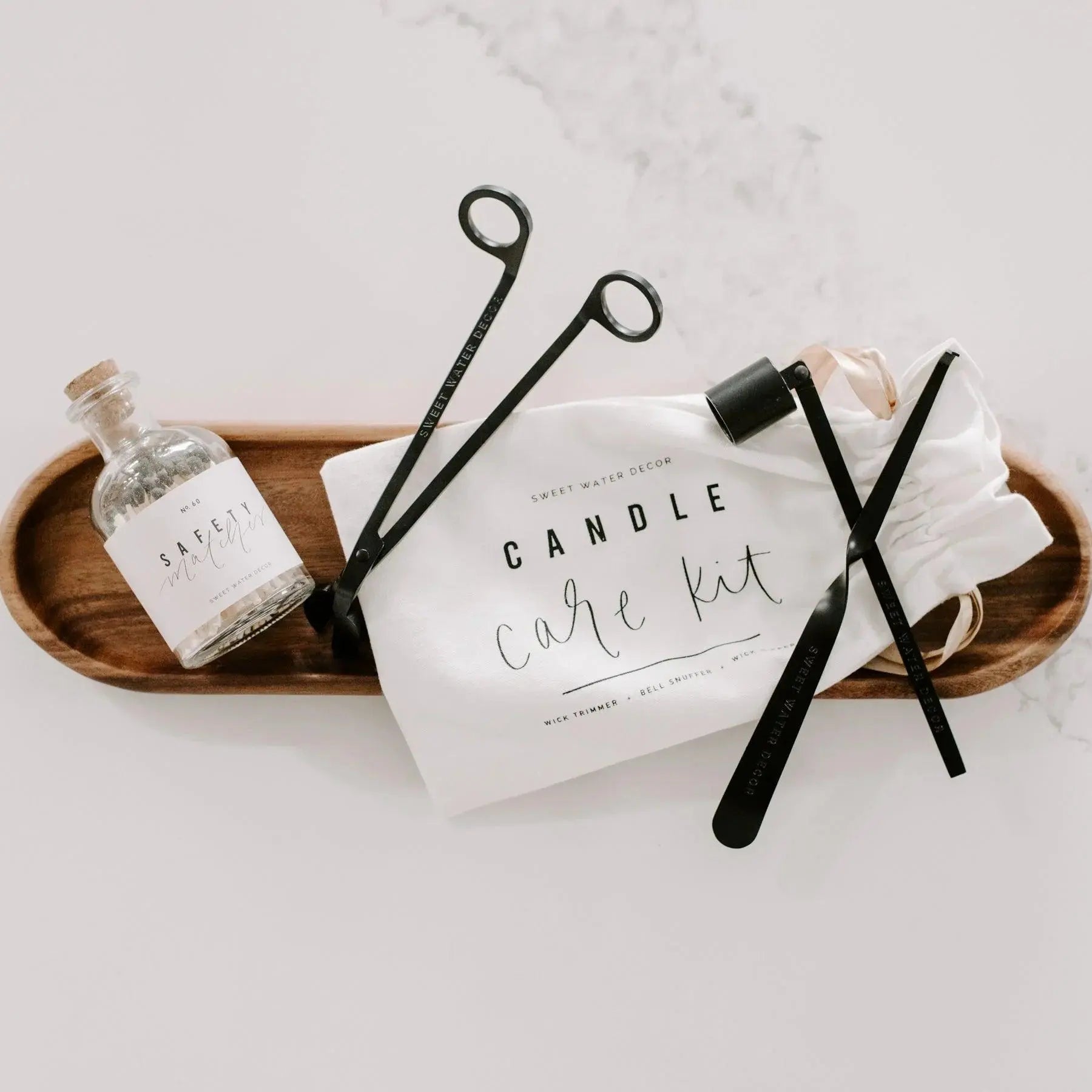 Candle care kit with wick trimmer, snuffer, and safety matches on wooden tray, farmhouse decor