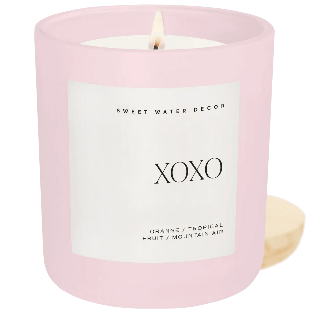 Pink ceramic XOXO candle with orange tropical fruit scent, cozy home decor