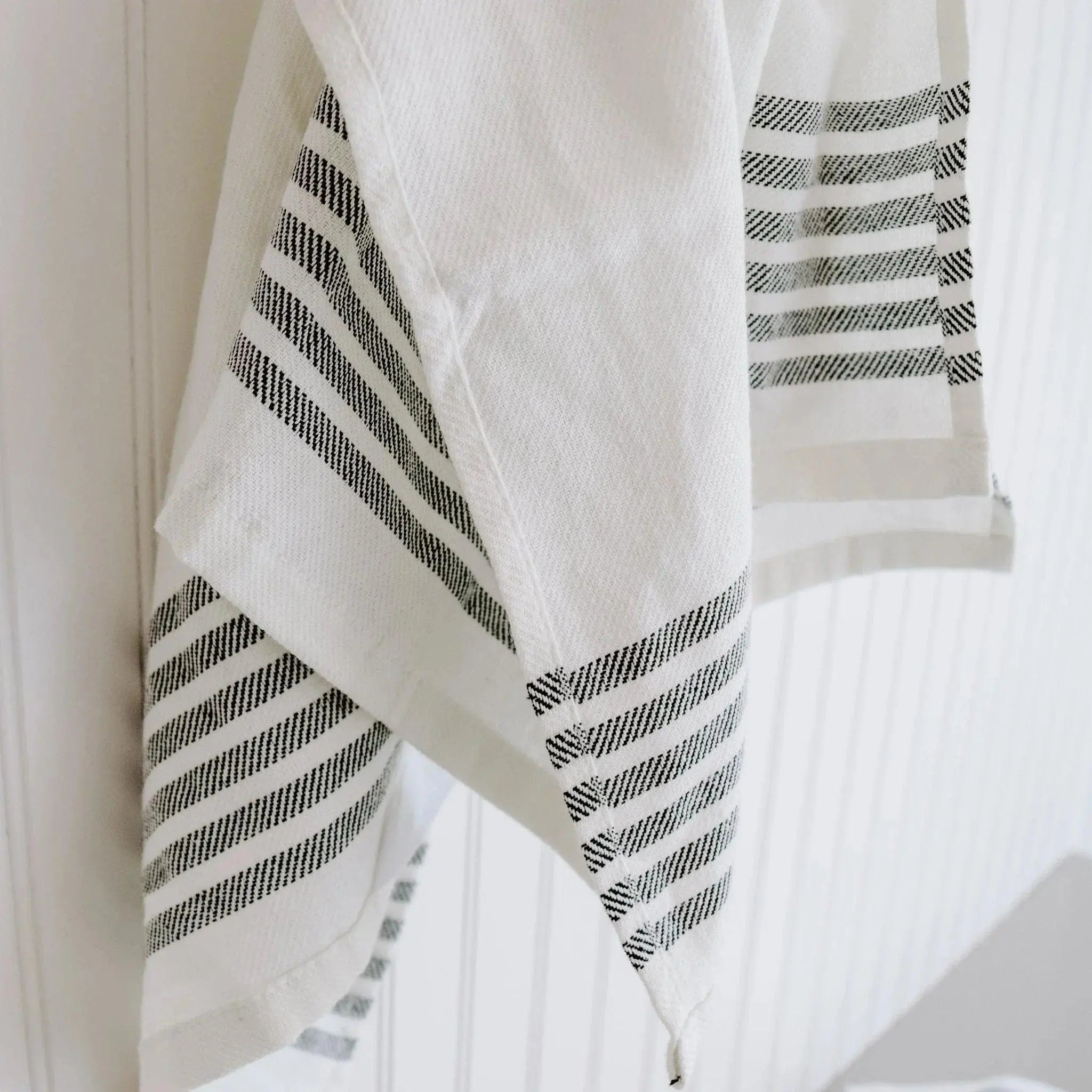 White farmhouse kitchen towel with black striped pattern, cozy cottage home decor
