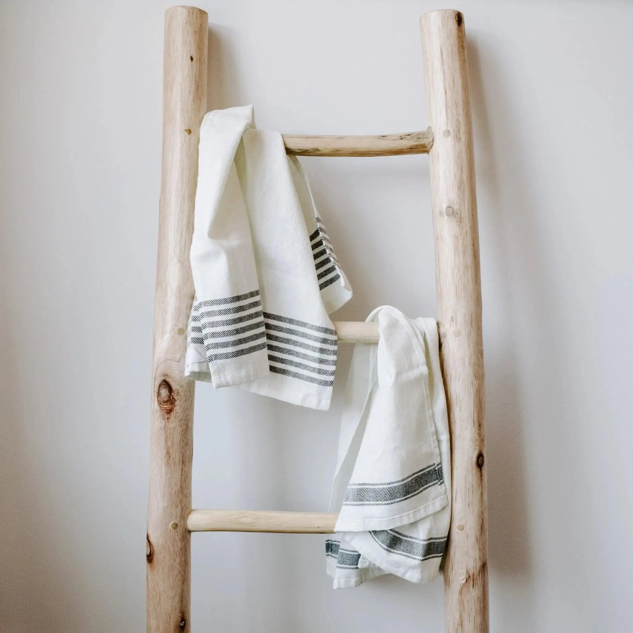 Rustic wooden ladder with striped farmhouse towels, cozy cottage decor