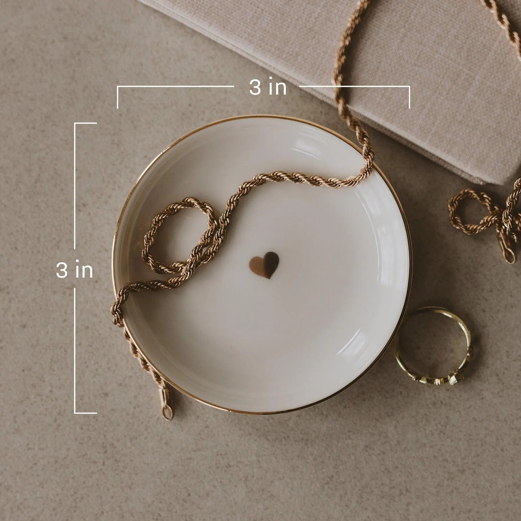 3-inch white ceramic dish with gold rim, holding gold rope chain and heart charm, farmhouse decor