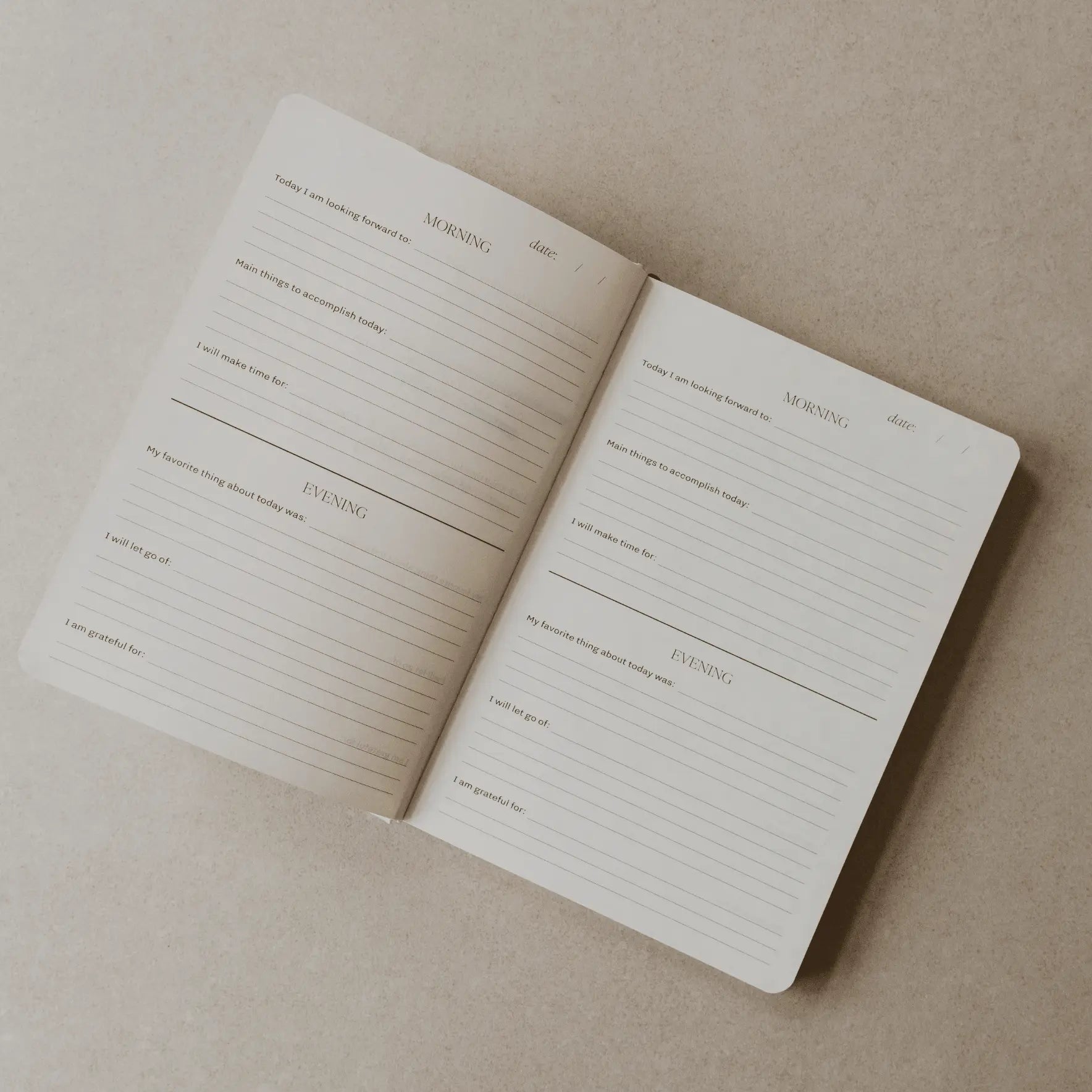Open notebook with lined pages on a beige background