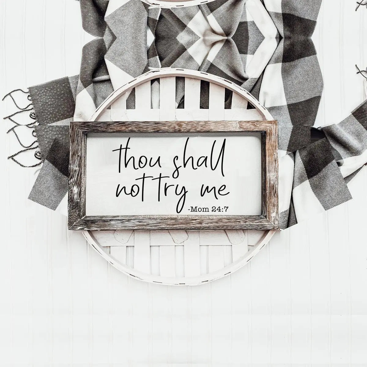 Decorative wall art with a wooden frame and motivational quote on a white background