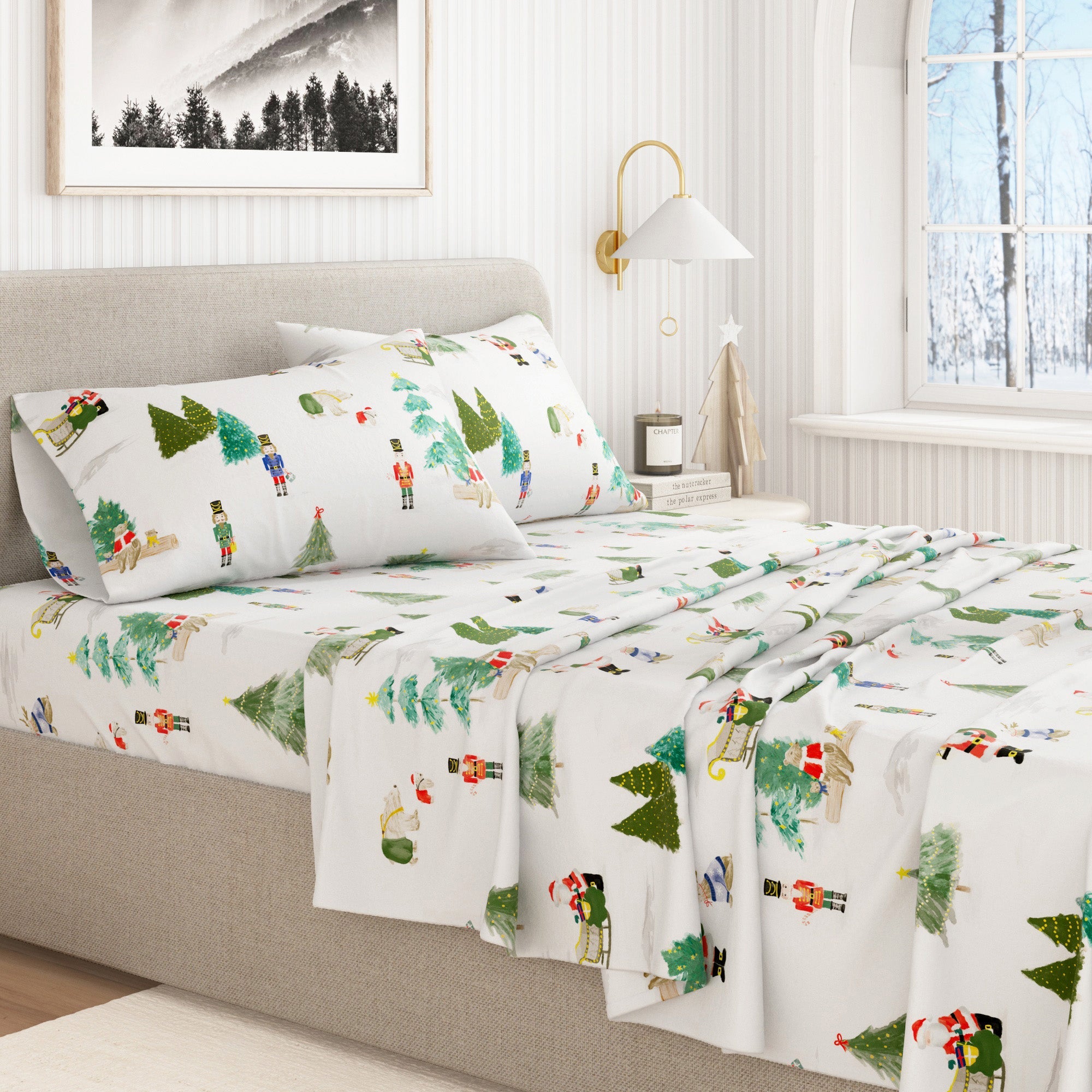 Bed with festive sheet set featuring Christmas trees and reindeer in a bedroom setting.