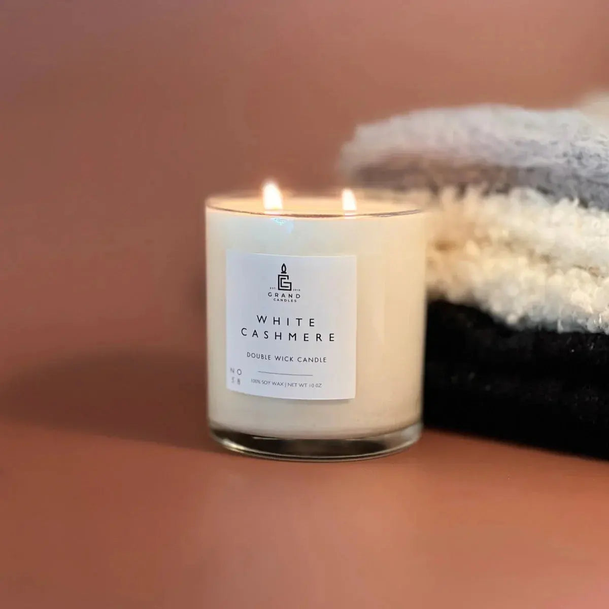 White Cashmere double wick soy candle lit beside cozy towels, farmhouse bath decor