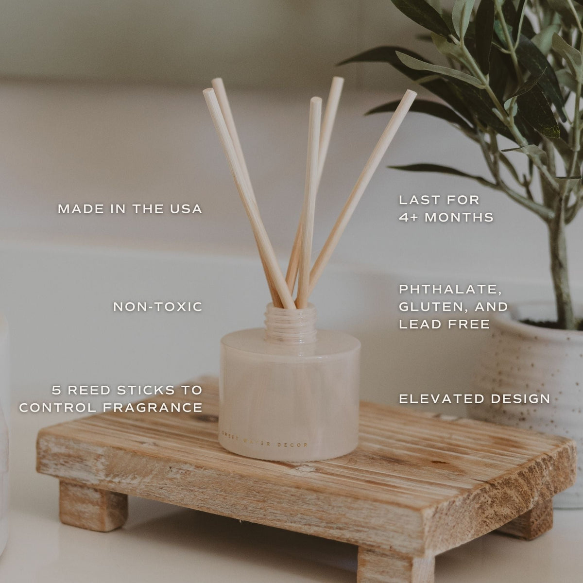 Reed diffuser with features listed on a wooden stand
