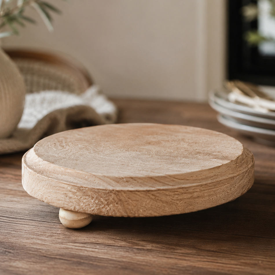 Round wooden coaster on a wooden surface with a blurred background