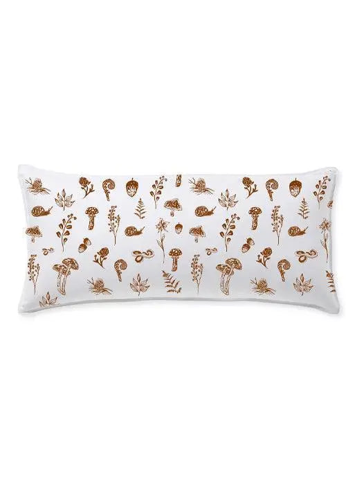 White lumbar pillow with brown mushroom, snail, and leaf print for cozy farmhouse decor